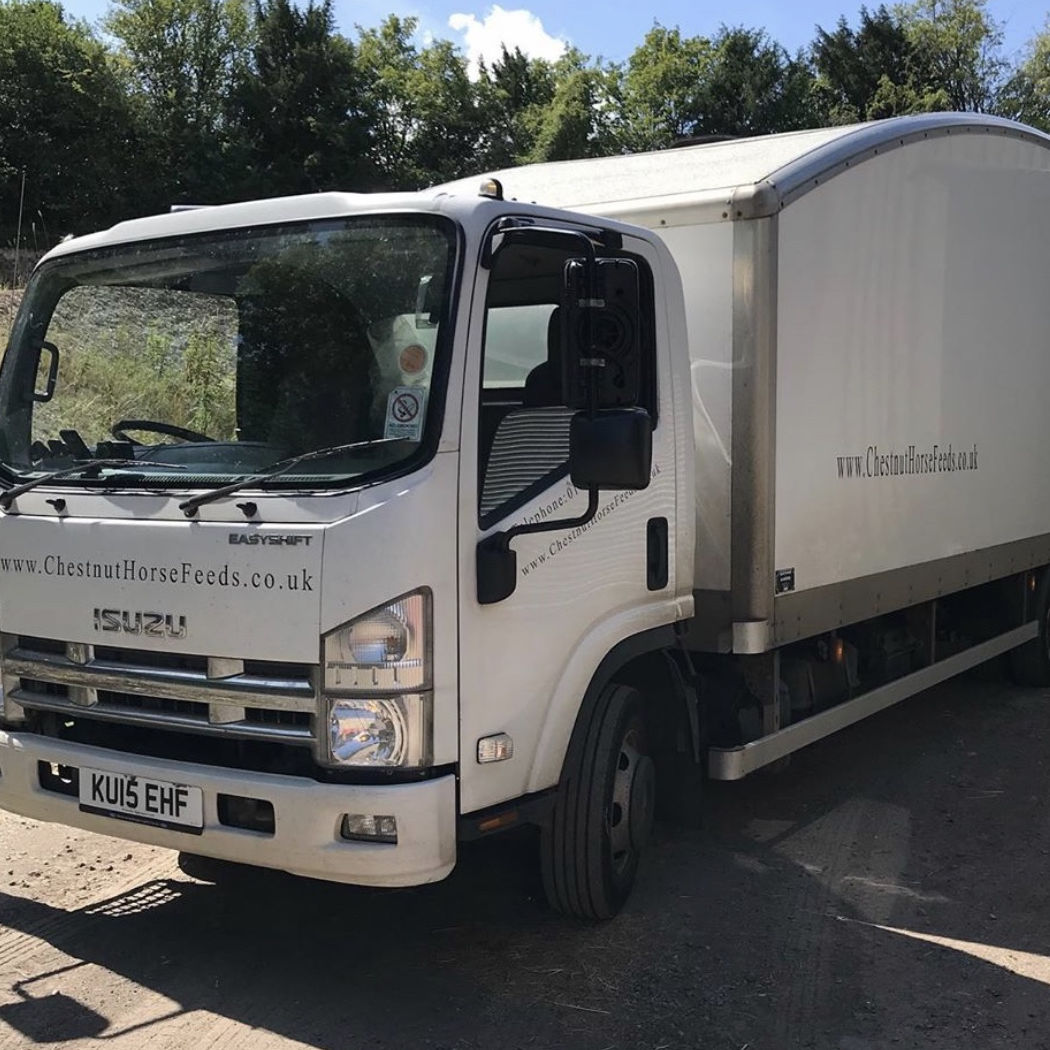 a photo of a man carefully loading a Bulk Bin into a van